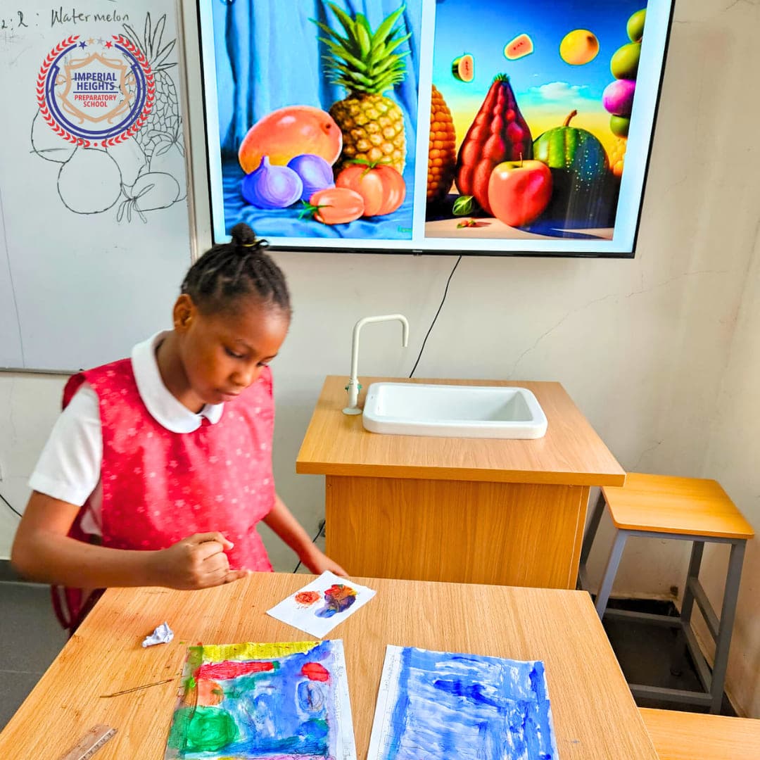 A pupil in her art apron painting a still life at the studio table