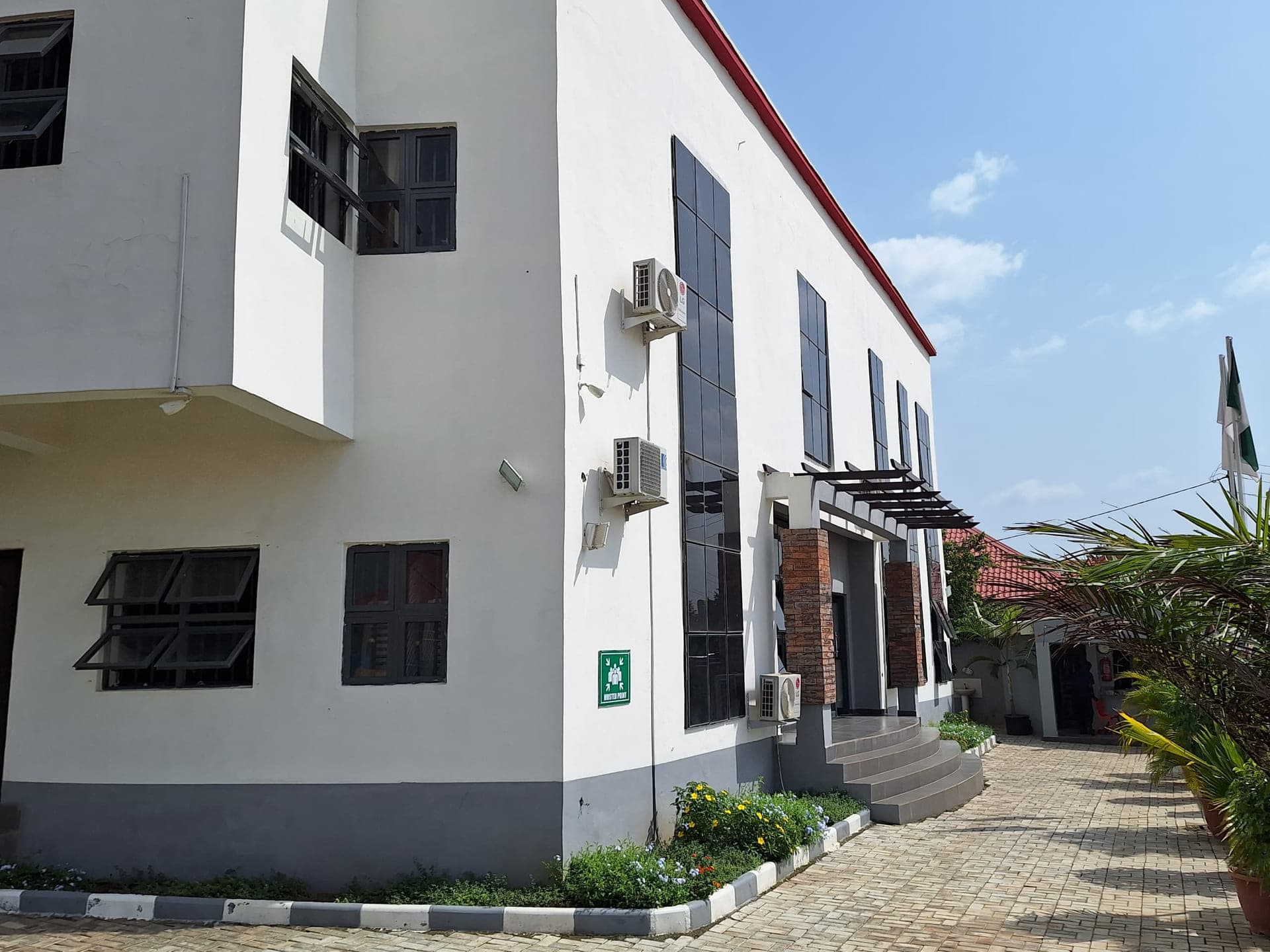 The main teaching block and its planted courtyard on a bright afternoon