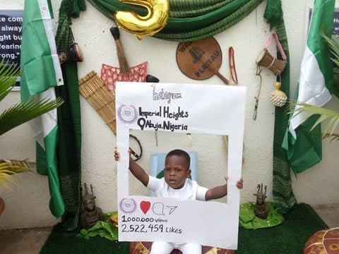 Posing at the photo frame during a school celebration