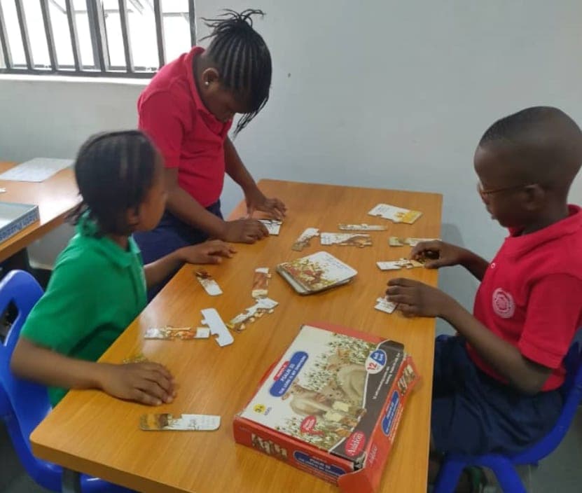 Pupils playing a board game together