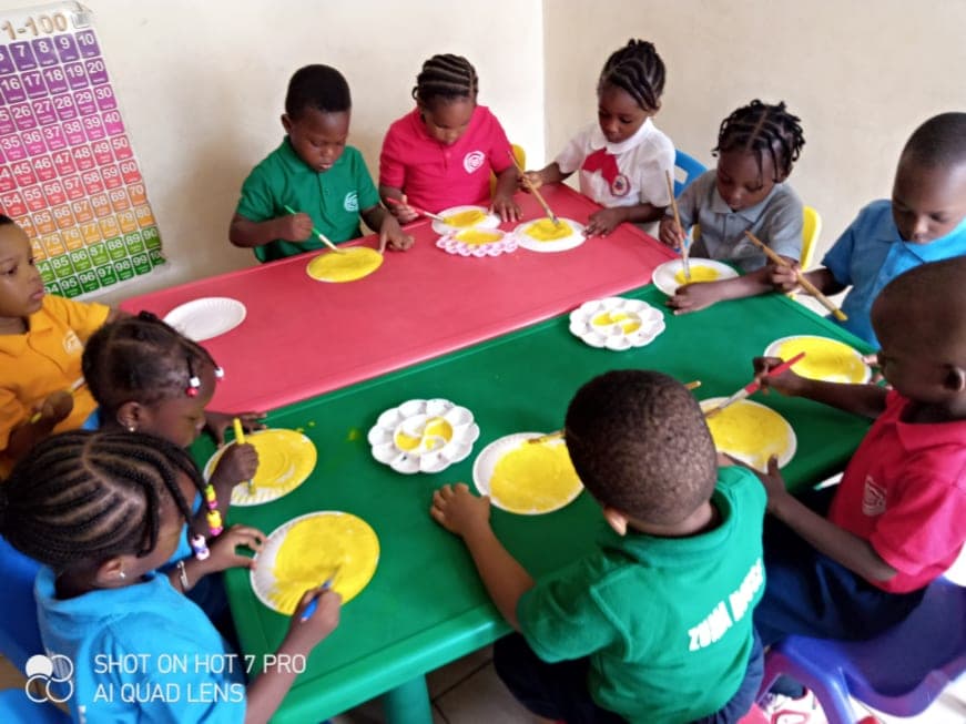Children sharing a snack around the classroom table