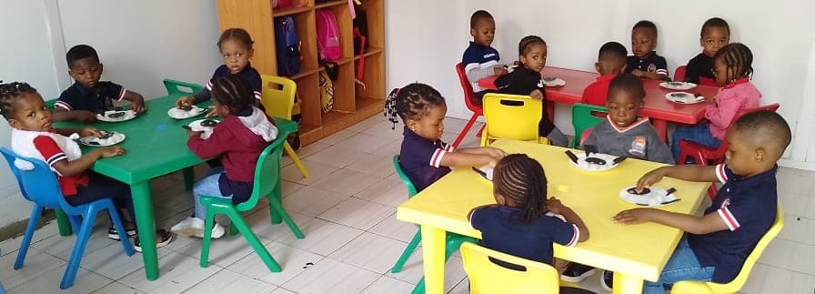 The crèche room, with children gathered around the low tables