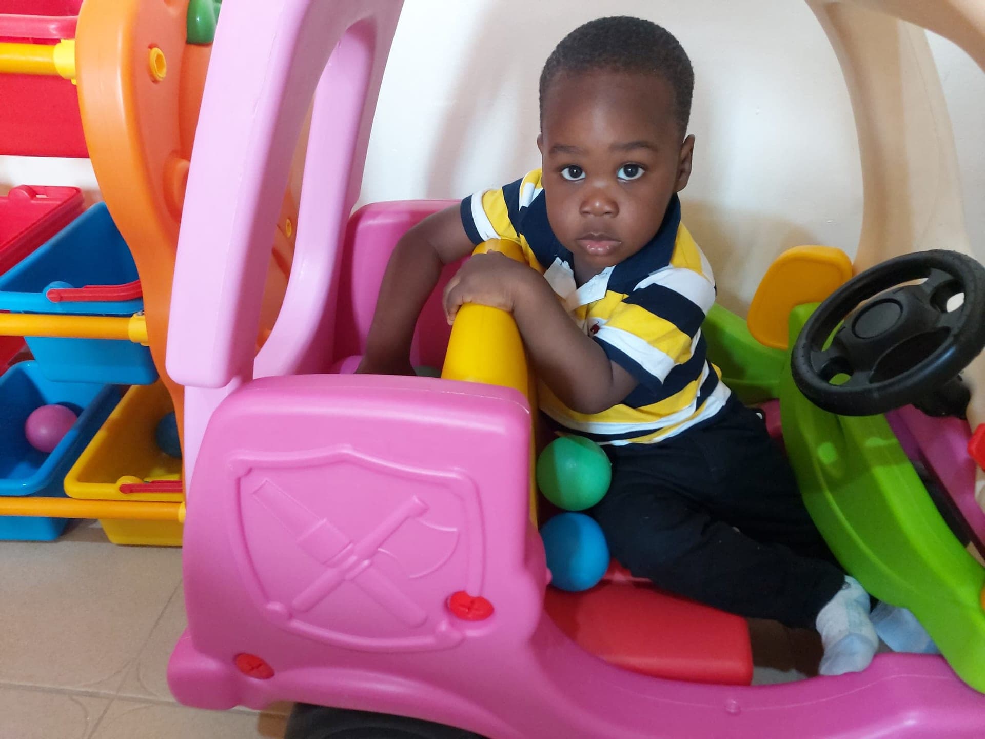 A toddler at the wheel of the ride-on toy car