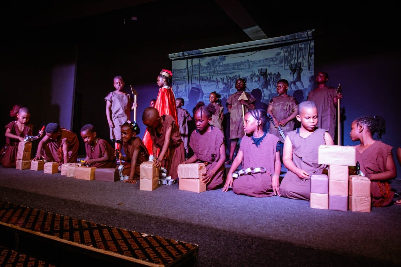 The full cast of our summer production under the stage lights