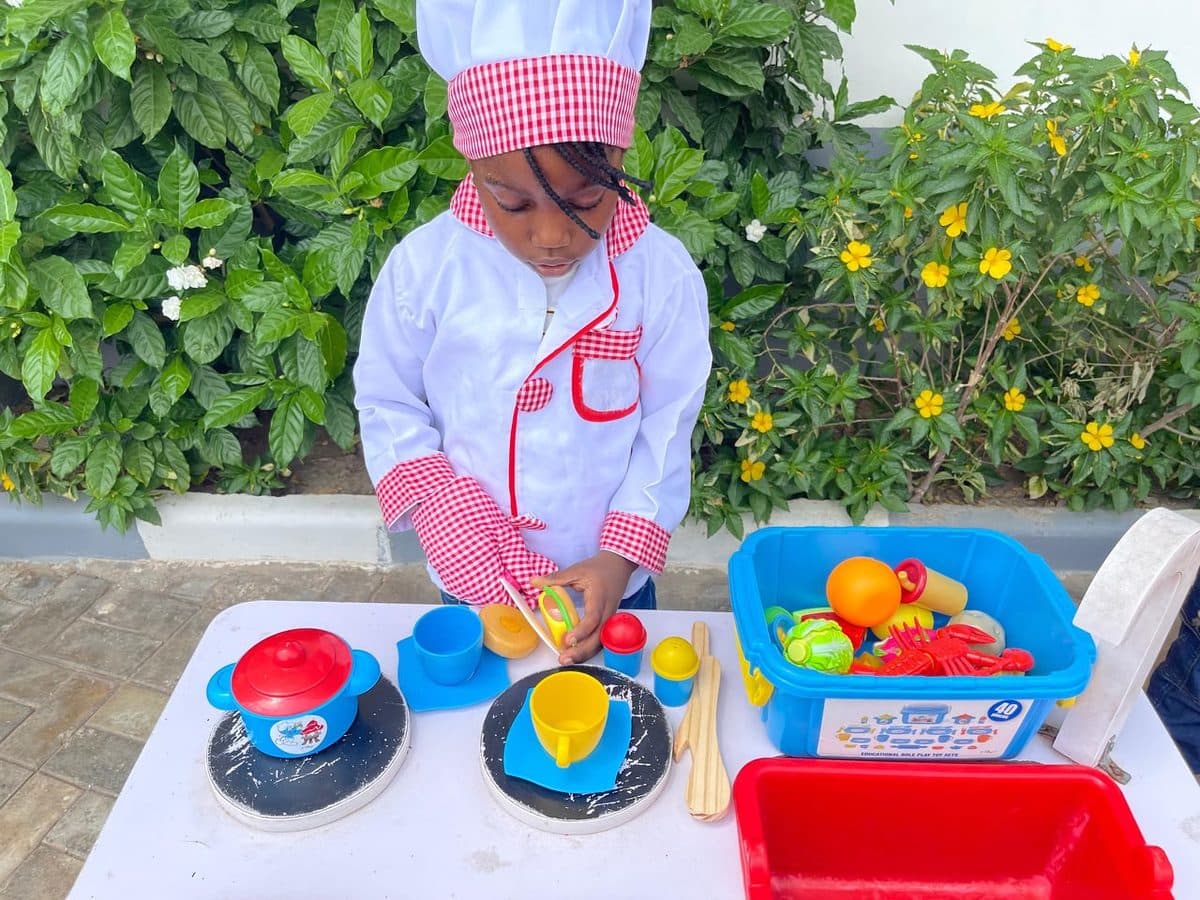 A young chef at the play kitchen