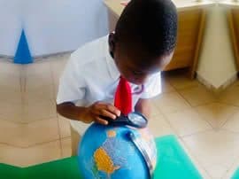 A pupil examining a globe