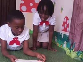A pupil reading in the book corner