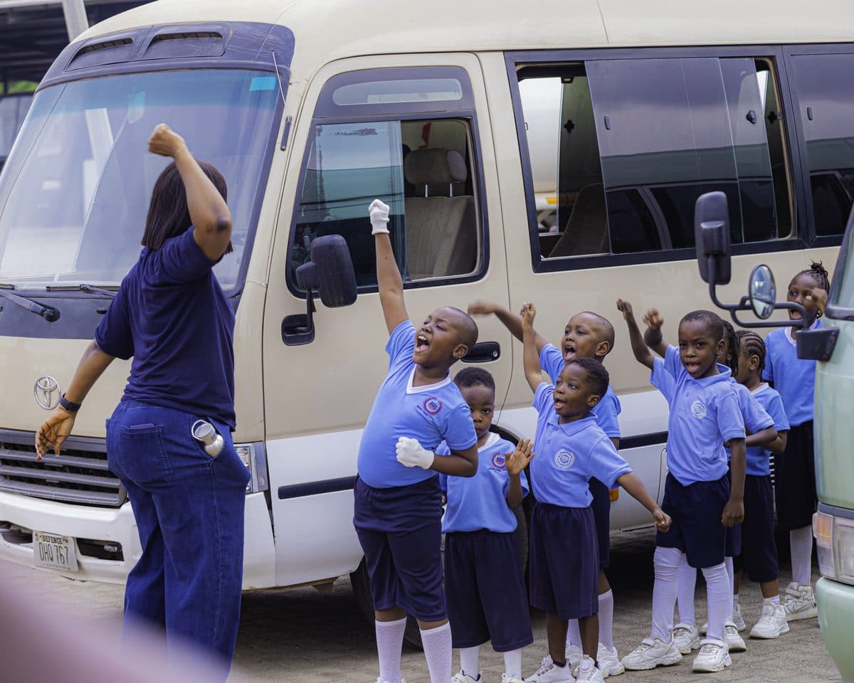 Waving from the school bus on the way to the stadium