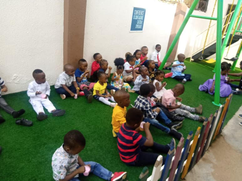 The whole school seated together on the floor for morning assembly