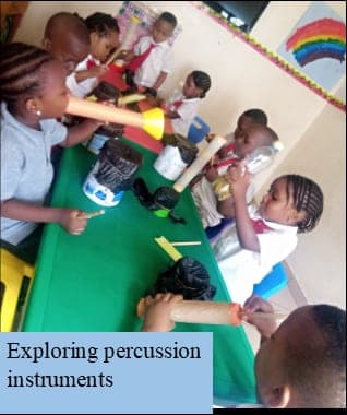 Children exploring percussion instruments in a music lesson