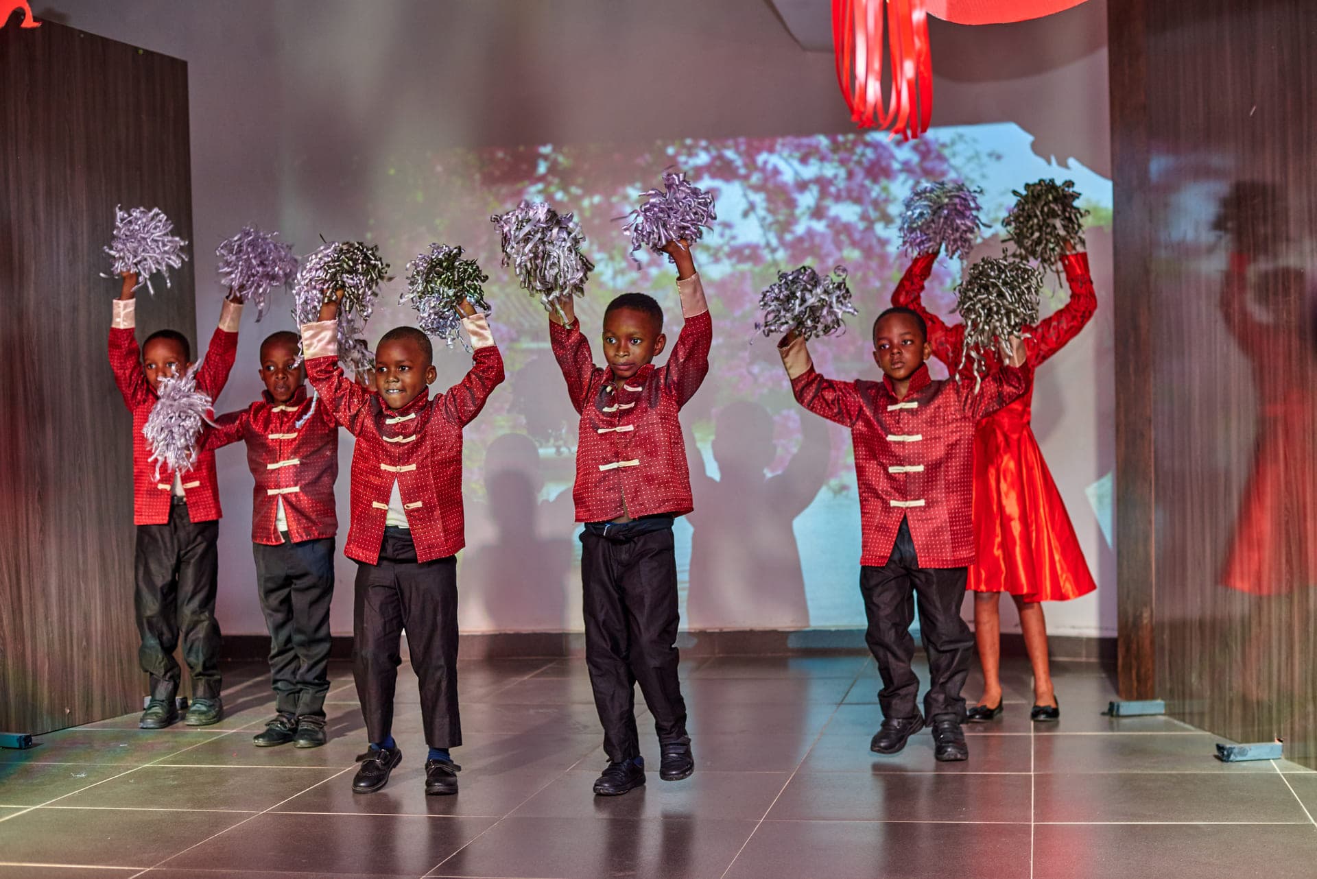 Pupils raising blossom branches during the Cultural Day dance