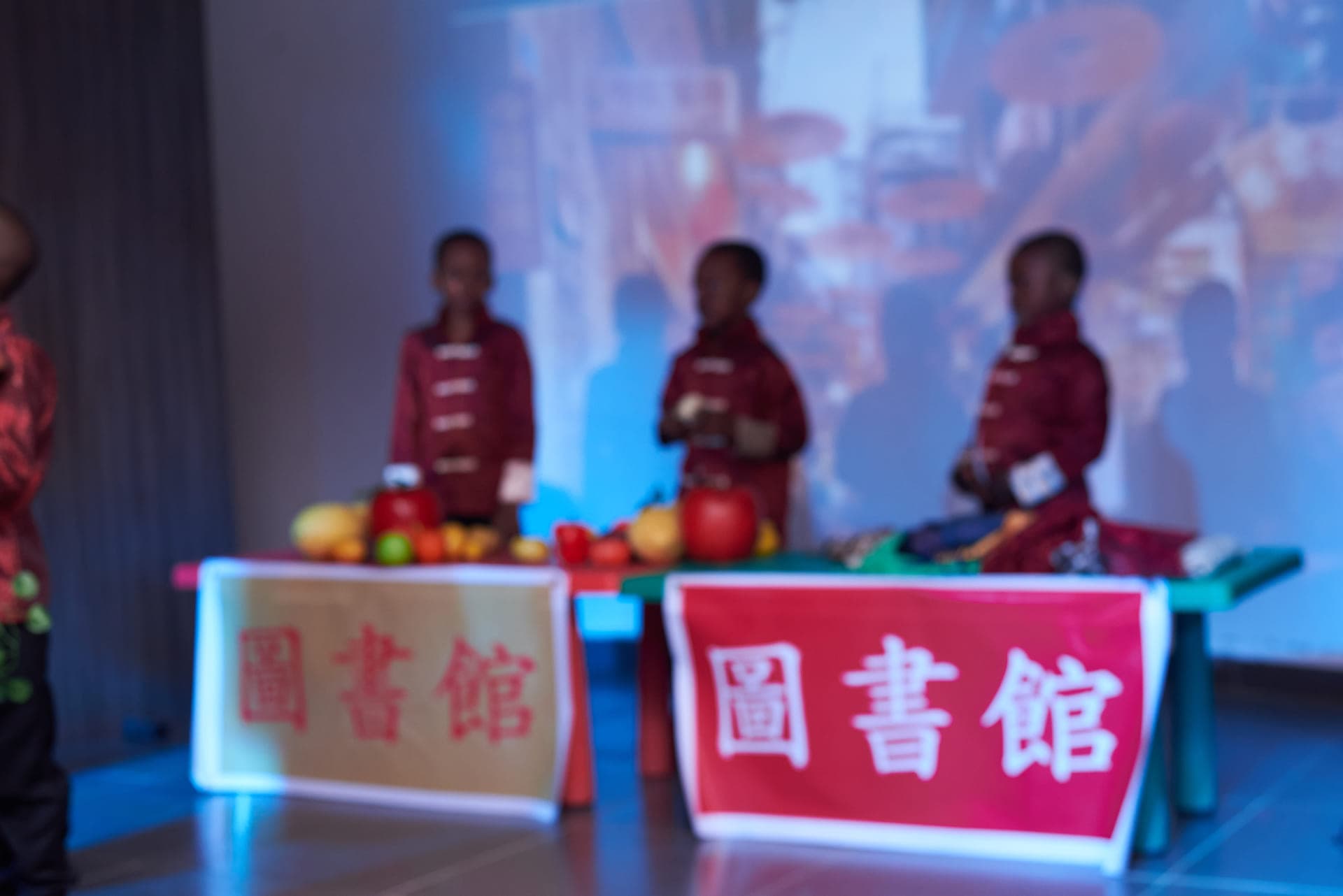 Pupils manning the market stalls in a scene from the Cultural Day play