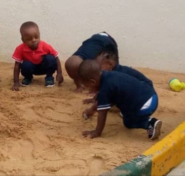 Two children digging in the sandpit