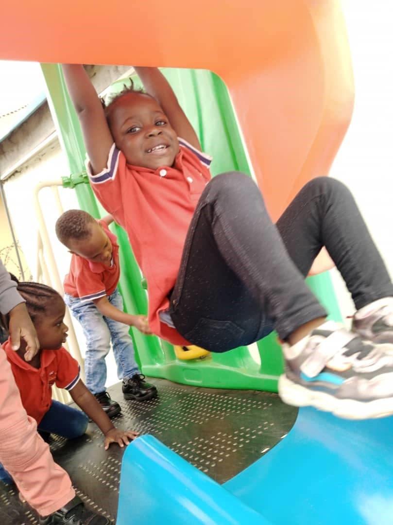 A pupil coming down the playground slide at full tilt