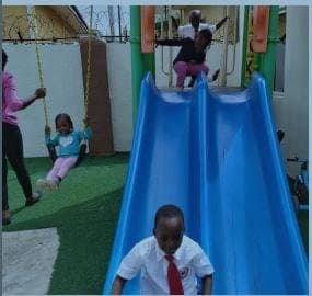 Pupils on the slide and swings at break time