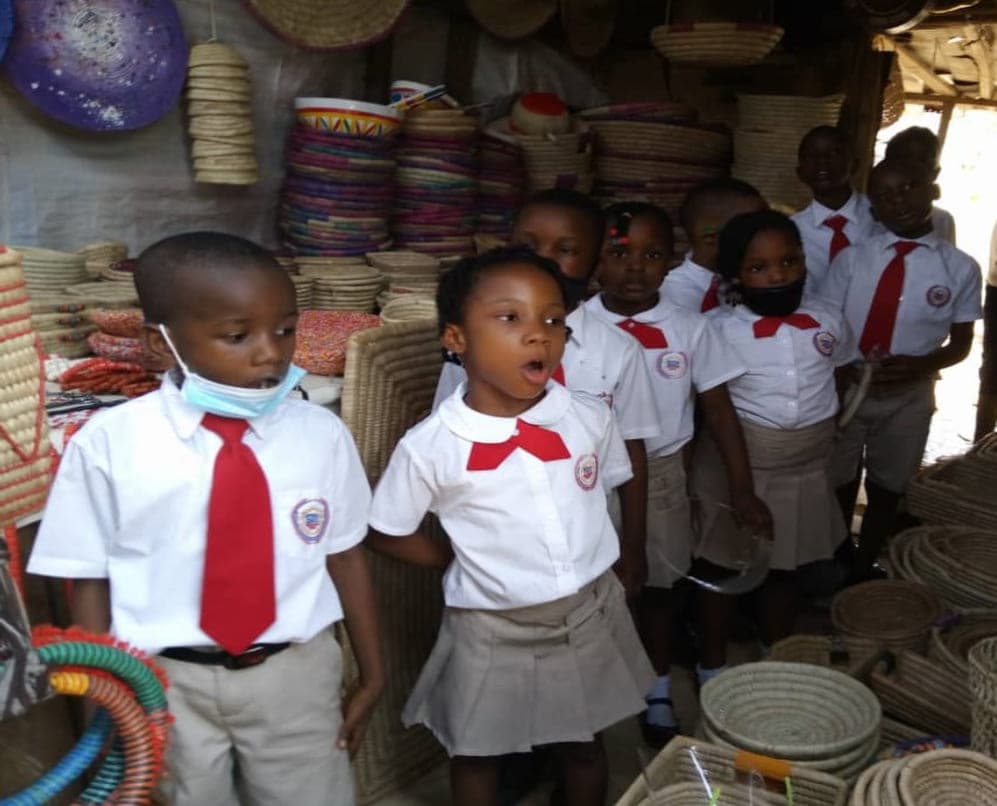 Pupils among the woven baskets and mats on a visit to the craft market