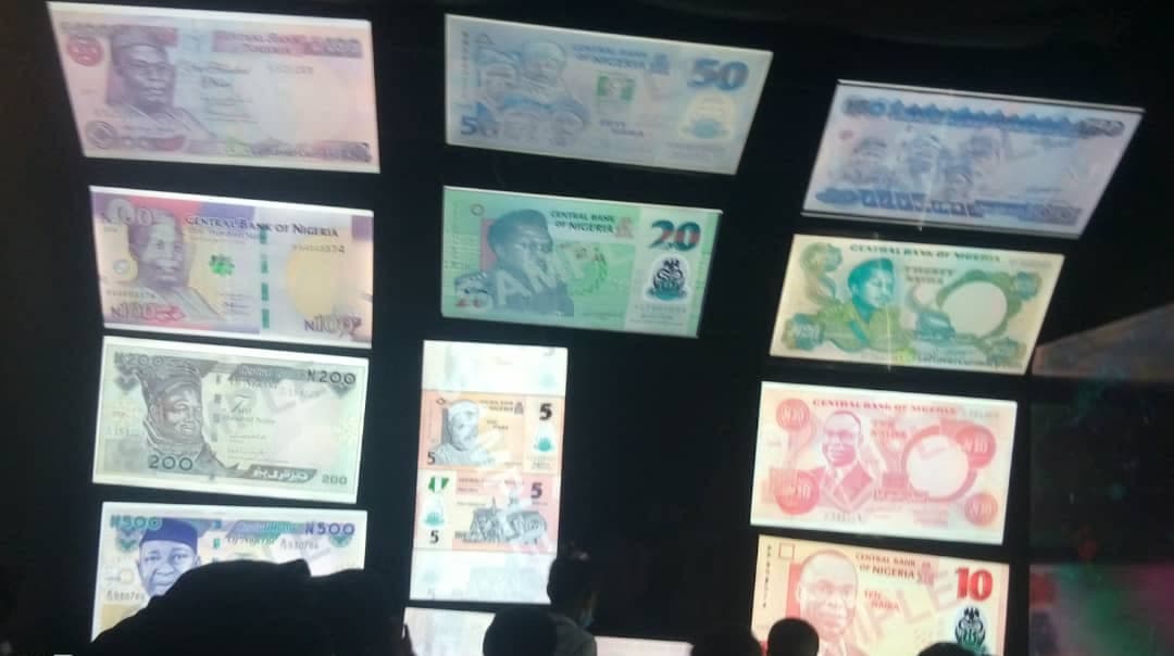Pupils looking over a display of historic Nigerian banknotes at the museum