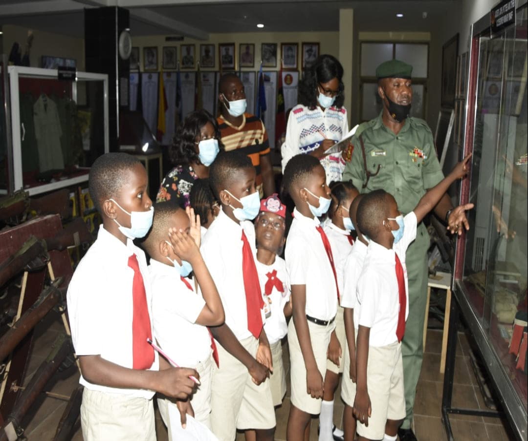 A guide talking our pupils through the display cases on a museum visit