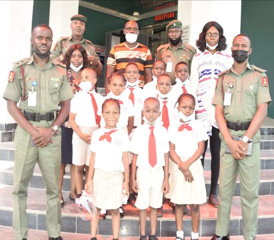 Pupils with officers of the Nigeria Security and Civil Defence Corps