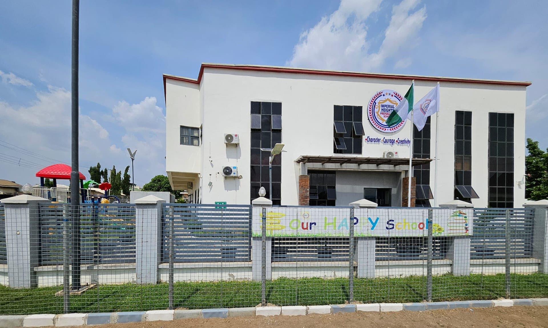 The school entrance and forecourt with the national flag flying