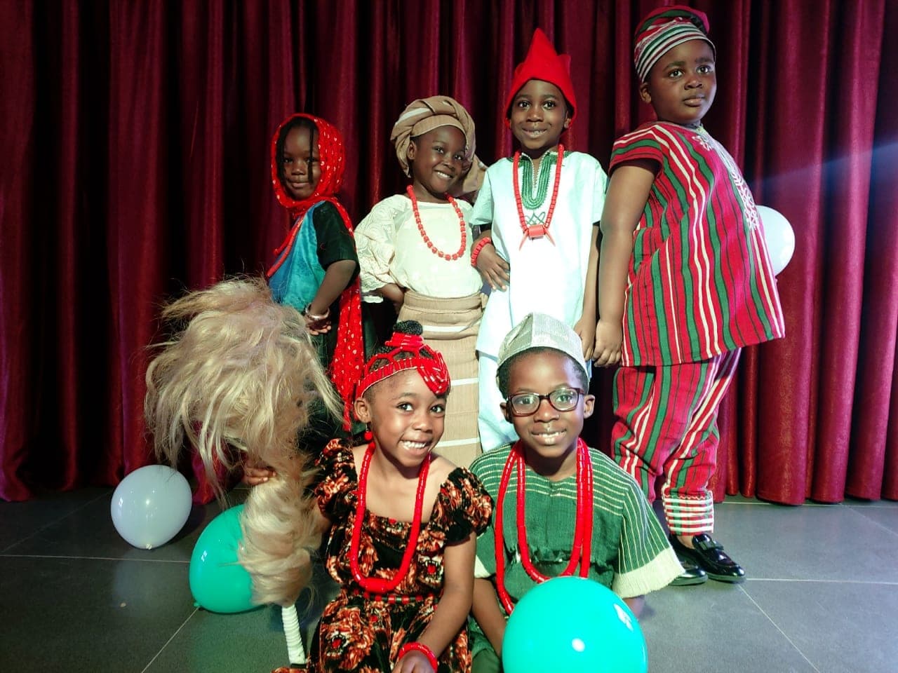 Pupils in traditional Nigerian dress on stage for Cultural Day