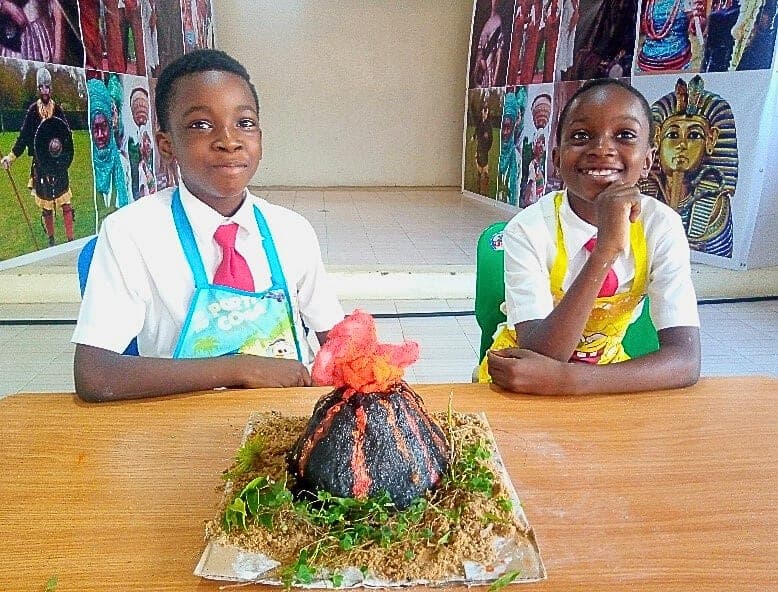 Two pupils presenting their erupting model volcano science project